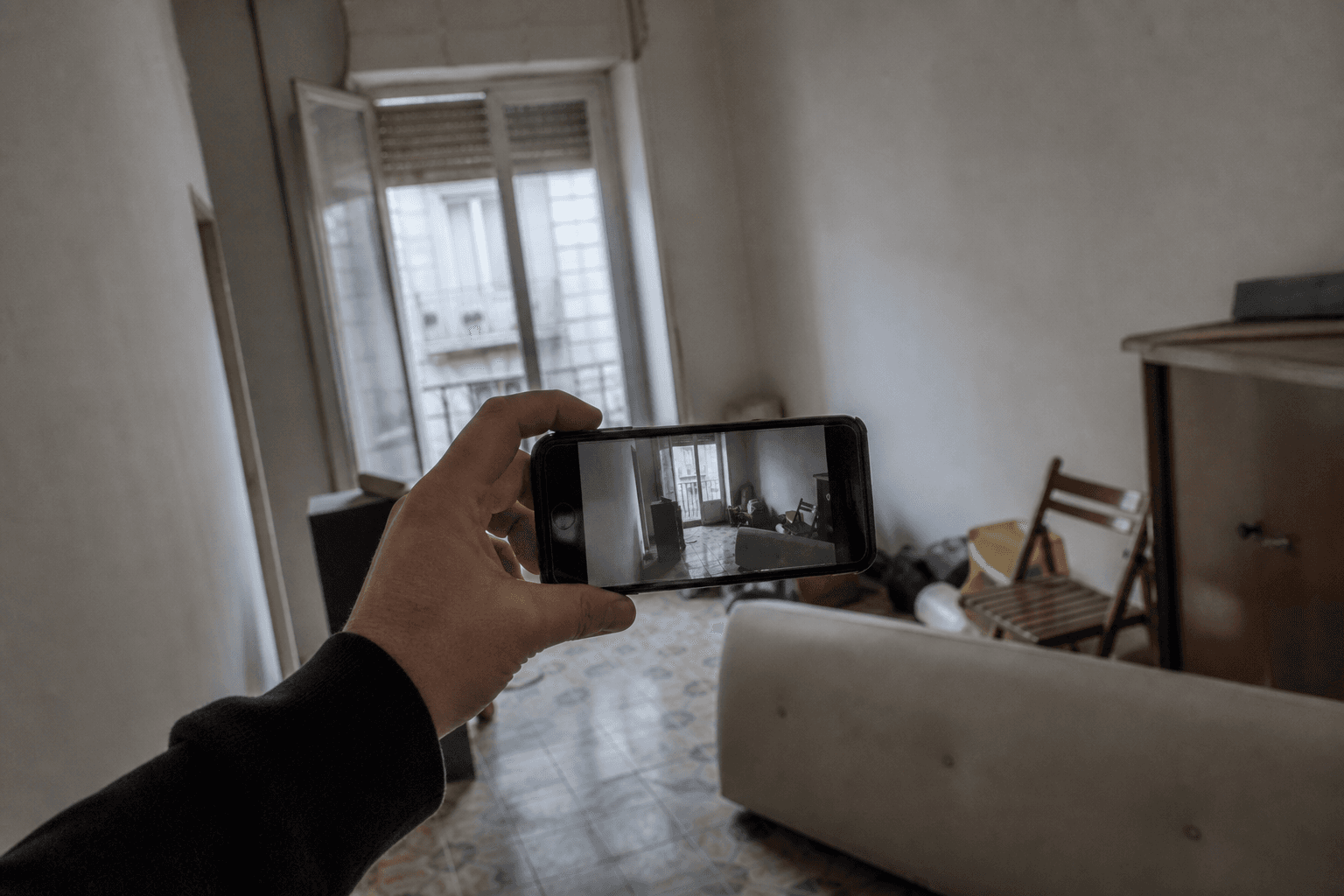 Someone taking a crooked phone photo of an empty room.